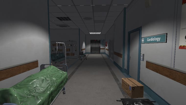 A corridor beneath a Cardiology sign leading to the closed elevator doors at the far end.